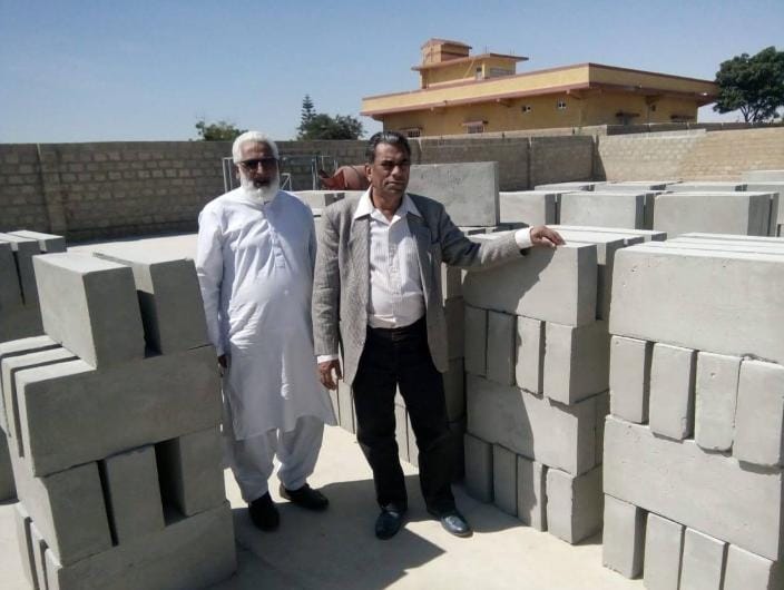 Clients inspecting foam concrete blocks quality at manufacturing site